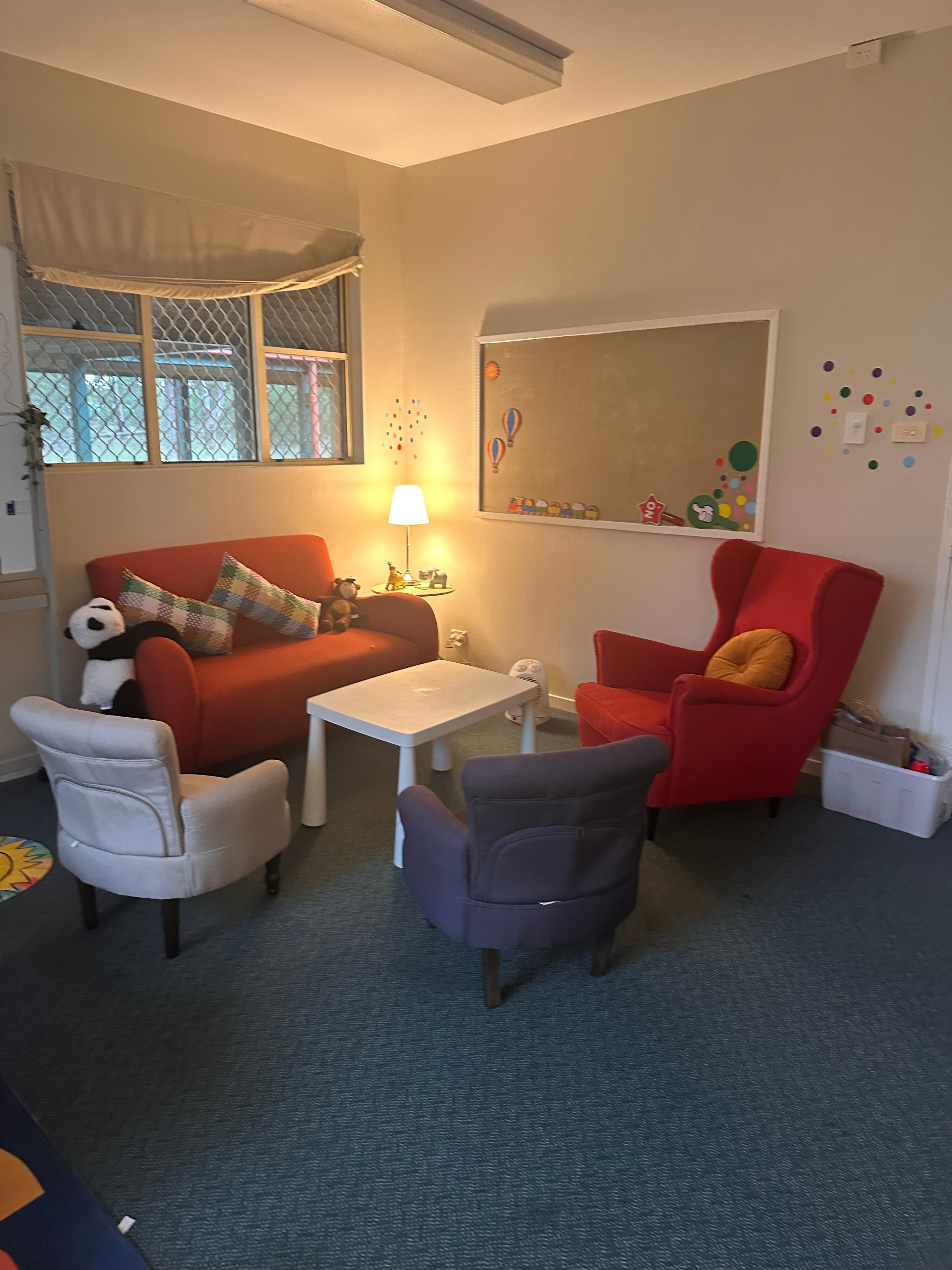 Kids counselling room with cosy seating and play materials